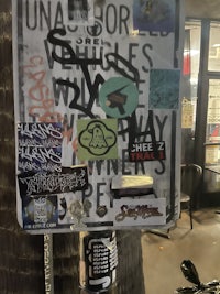 a sign with a lot of stickers on it